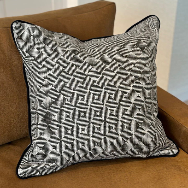 Luxury cushion in a black and white geometric pattern, with black piping. A plump feather inner cushion is included. Our made to order cushions are plump and cosy.  Dimensions: 600 x 600 mm  Made to order in approx 3 weeks