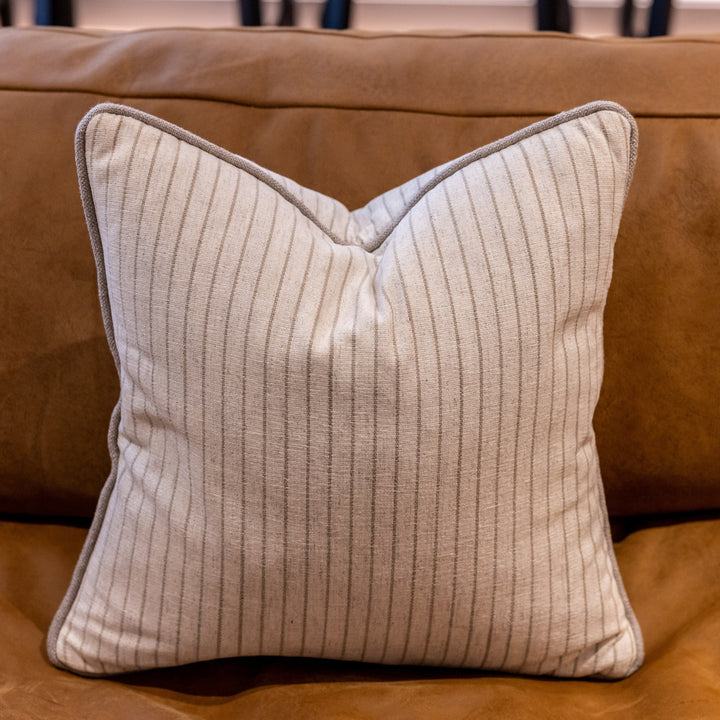 Luxury striped linen mix fabric cushion with a taupe coloured piping. Colour is cream with a taupe colored stripe 12mm apart. A plump feather inner cushion is included. Our made to order cushions are plump and cosy.  Dimensions: 500 x 500 mm  Made to order in approx 3 weeks